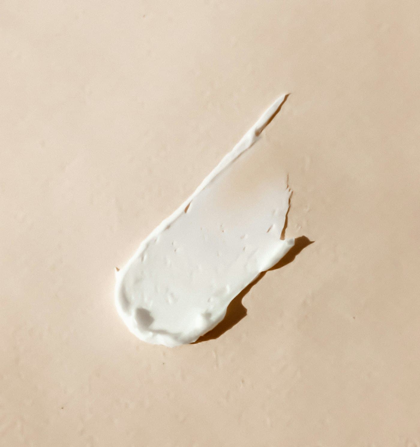 A swipe of cream on a warm neutral surface